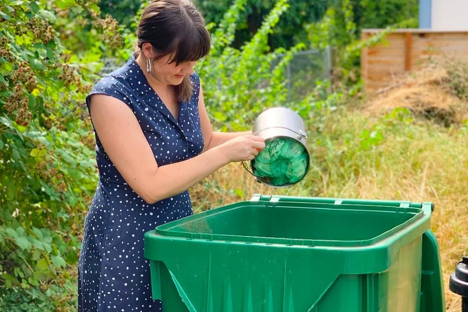 Lady throwing compost items in the compost bin